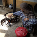 A woman cooking, Swat, KP, July 19, 2011