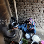 An old woman cooking, Dadu, Sindh, December 30, 2016