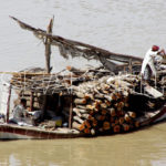 Transporting goods in boats, Indus River, Sukkur, Sindh, April 9, 2009